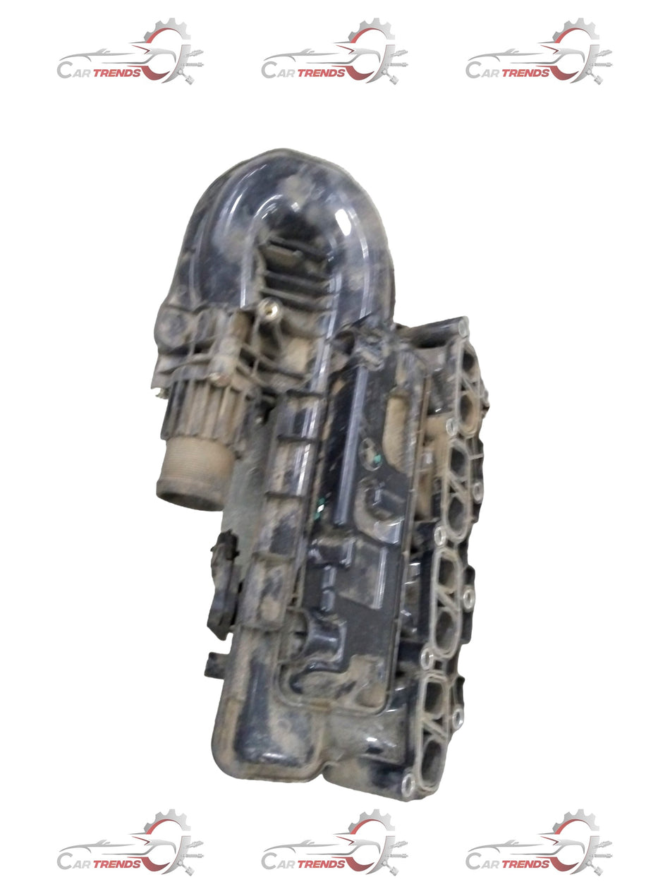 Chevrolet Enjoy manifold intake by General Motors, automotive engine part with metal and plastic components visible.