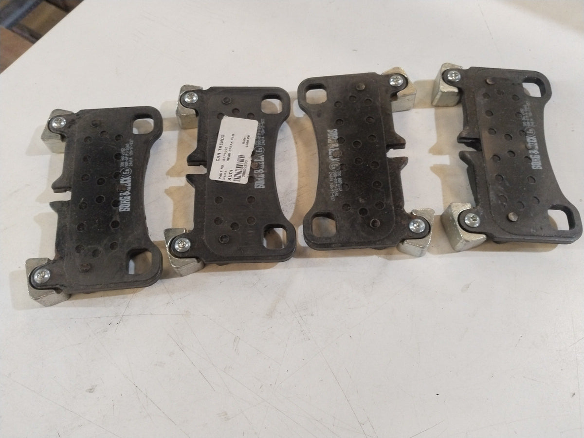 Aftermarket front brake pad for Audi Q7, shown in black with metal backing, designed for reliable vehicle braking performance.