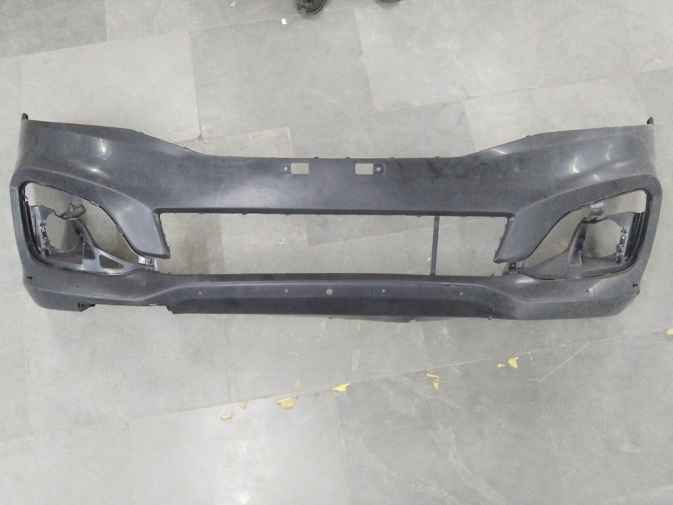 Maruti Suzuki Ertiga 2nd Gen front bumper for petrol, diesel, and CNG models, showcasing the black plastic bumper with mounting points.
