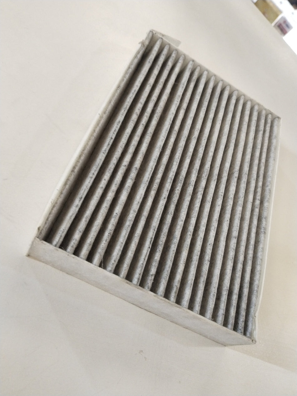 CarTrends AC Ritz #LAK 1167, automotive air conditioning component with visible metal and plastic parts, mounted on a vehicle.