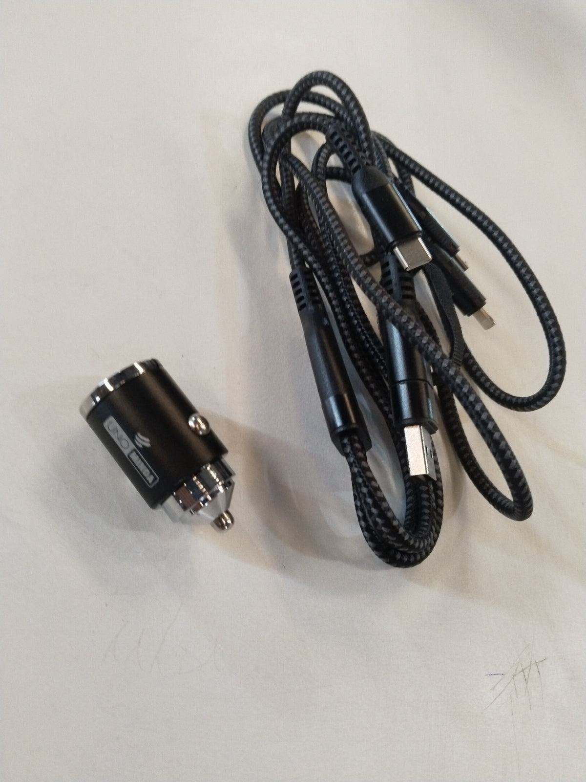 CarTrends 100W fast car charger with 5-in-1 cable and multiple connectors, shown plugged into a vehicle's power outlet.