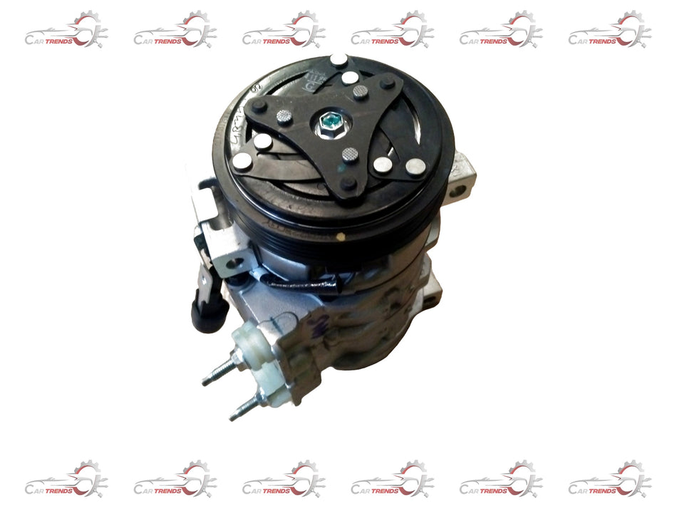 CarTrends 138CC air conditioner compressor for Mahindra Scorpio, view of the compact, metallic compressor part with hoses and fittings.