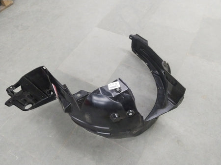 Honda Brio LH front inner fender assembly, OEM part with metal and plastic components, shown in a close-up shot.