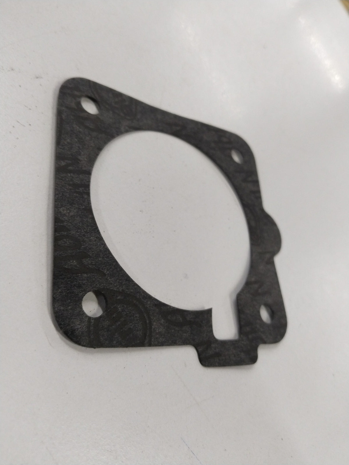 Fuel injector gasket and meter body for Chevrolet Corsa by General Motors, showing the gasket and fuel meter components.