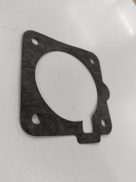 Fuel injector gasket and meter body for Chevrolet Corsa by General Motors, showing the gasket and fuel meter components.