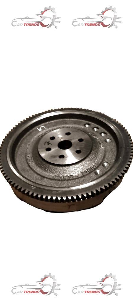 Maruti Suzuki flywheel showing metal gear and circular disc part for vehicle engine repair or replacement.