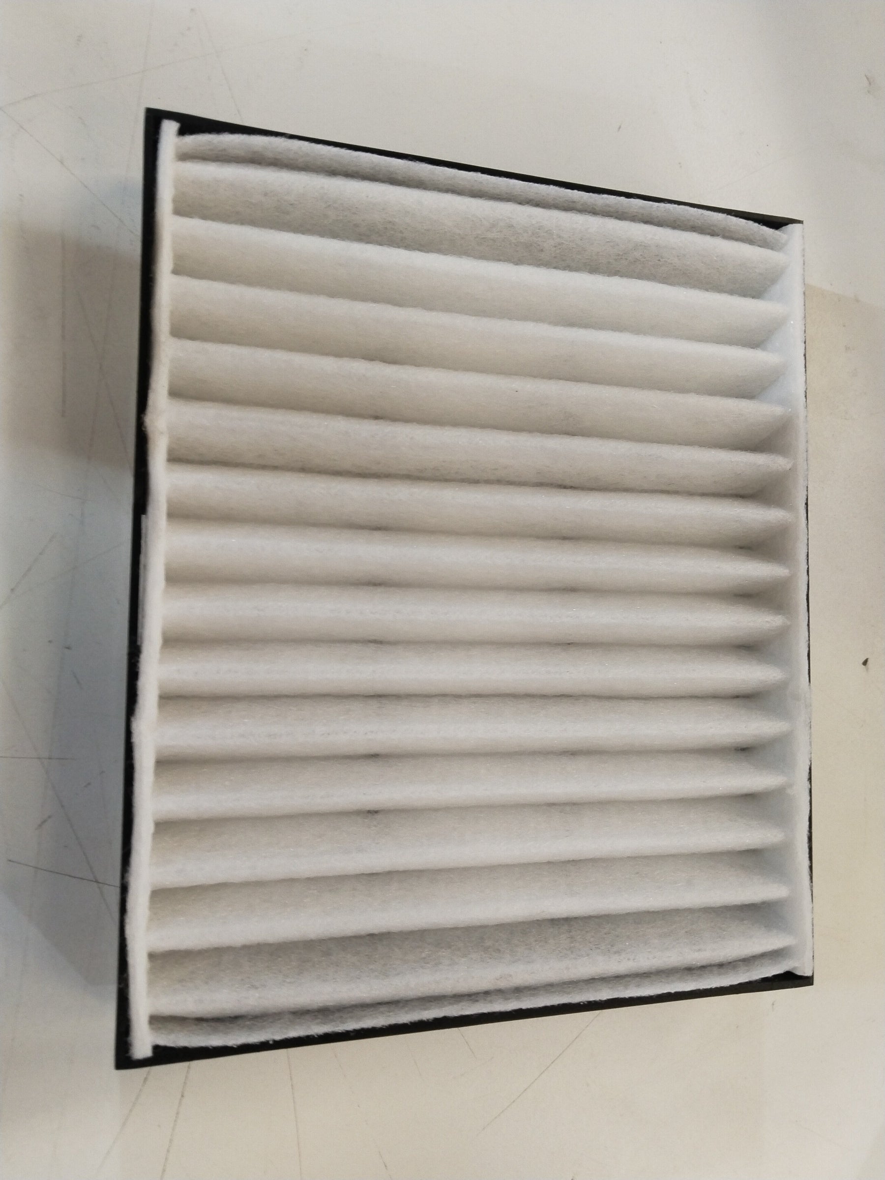 Maruti Suzuki AC filter Celerio model 990J0M76MS0010, rectangular car air conditioning filter with black frame and pleated filter material.