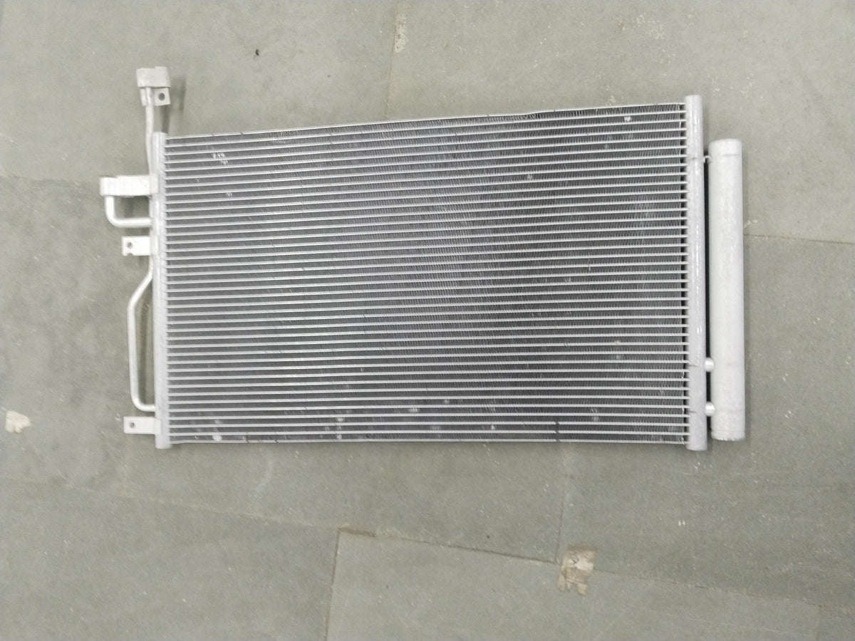 General Motors Chevrolet Captiva condenser AC unit showing metal fins and connections for vehicle cooling system.