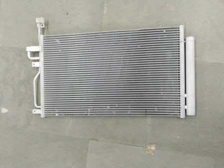 General Motors Chevrolet Captiva condenser AC unit showing metal fins and connections for vehicle cooling system.