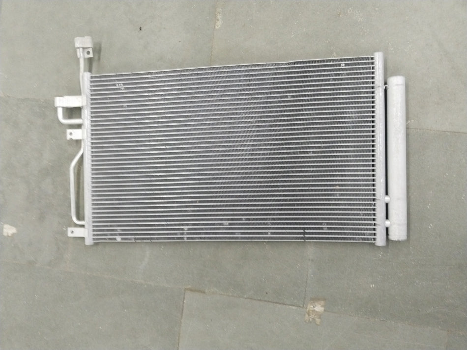 General Motors Chevrolet Captiva condenser AC unit showing metal fins and connections for vehicle cooling system.