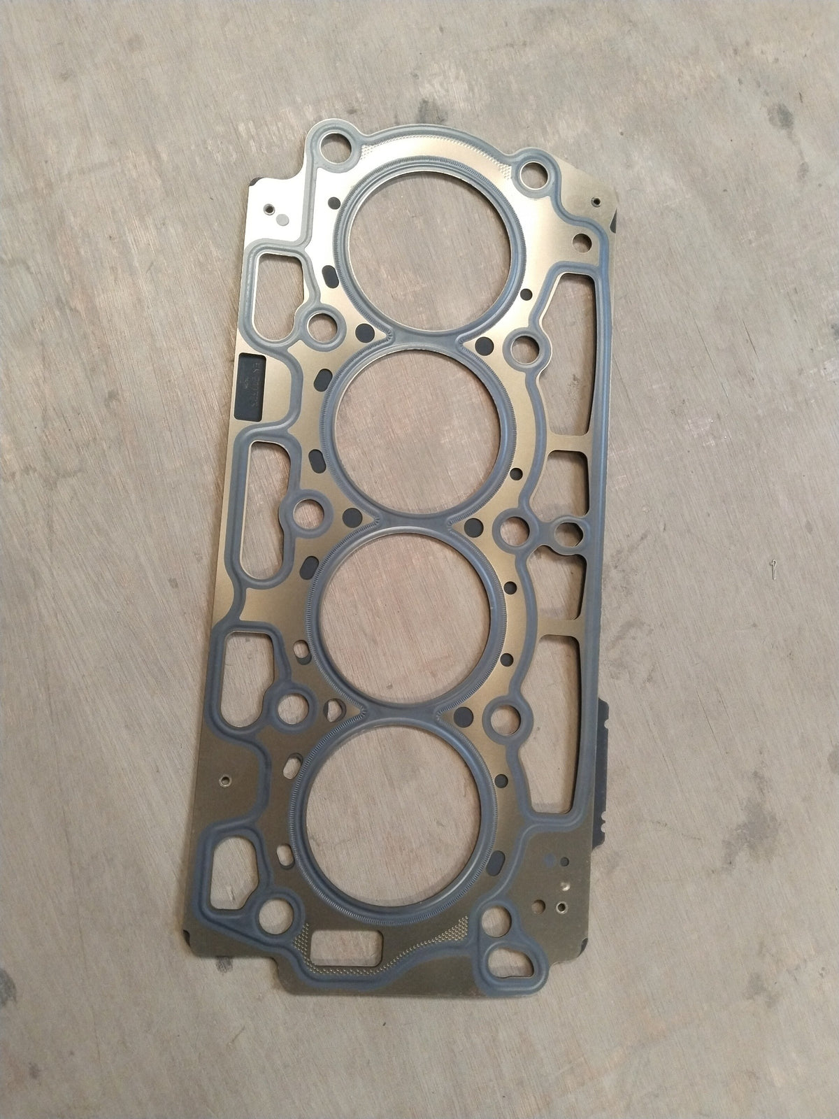 CarTrends Ford cylinder head gasket AV2Z6051C showing the gasket's shape and material for engine sealing.