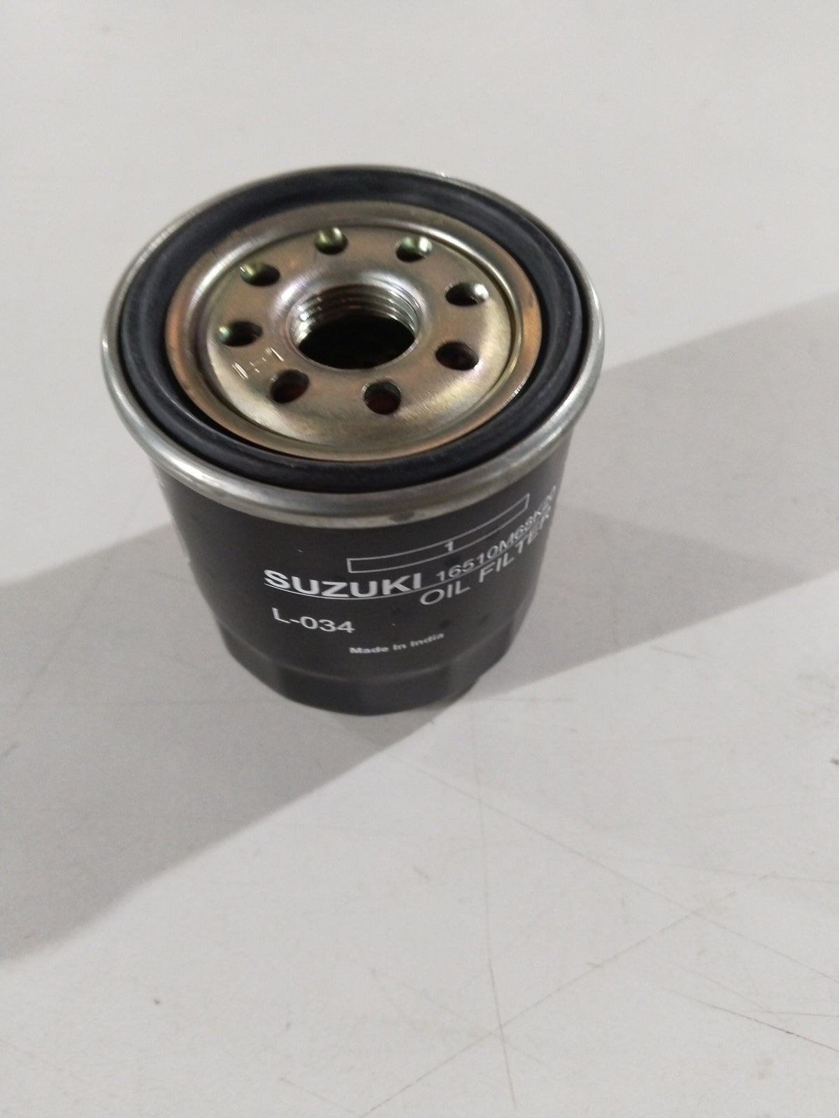Suzuki oil filter spare part by CarTrends, model #16510M68K20, detailed close-up of the cylindrical filter component.
