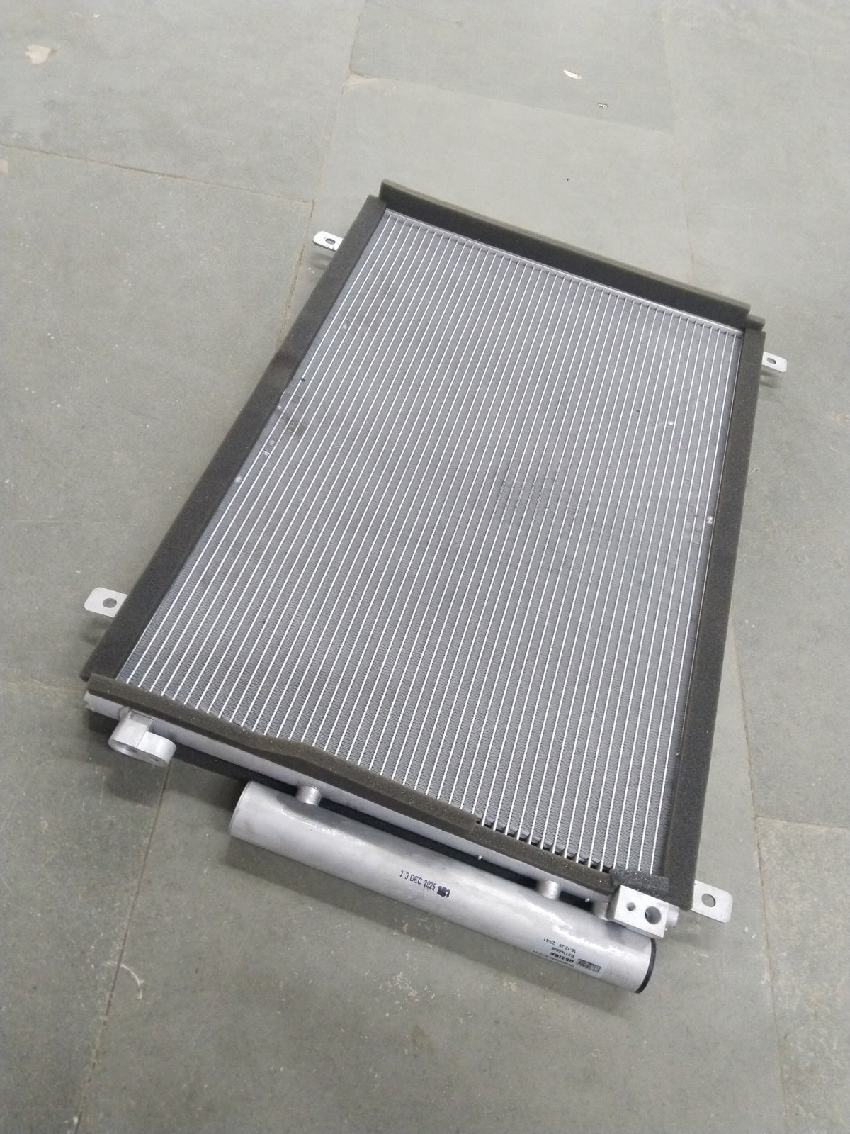 CarTrends Swift Deizre Type 3 condenser for automotive cooling, showing the compact metal core and fittings.