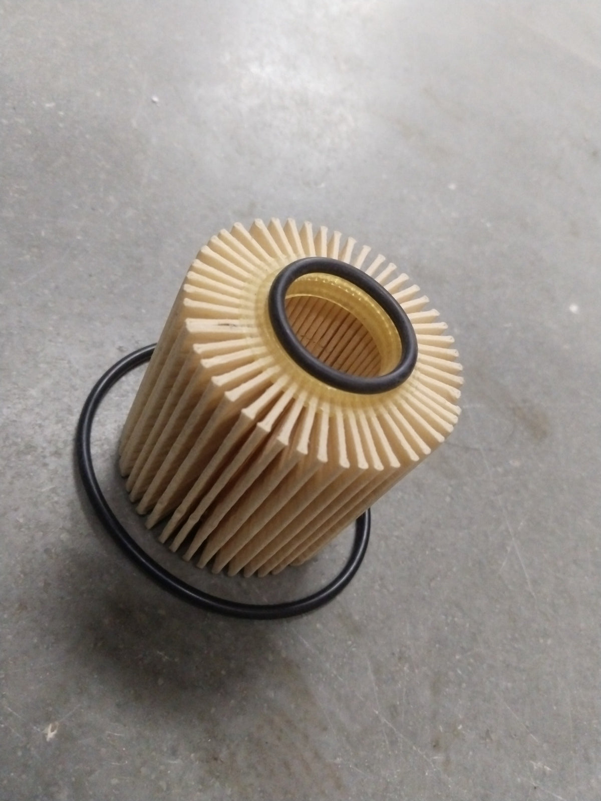 Toyota Camry oil filter spare part branded CarTrends, showing the black cylindrical filter with mounting details.