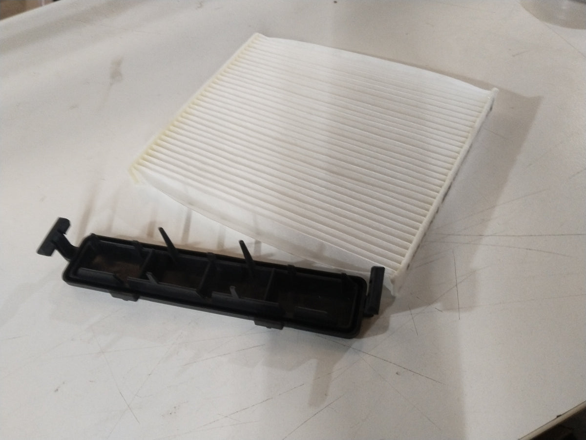 CarTrends 990J0M79GS0010 AC filter spare part shown in image, featuring a rectangular black filter component for vehicle air conditioning systems.