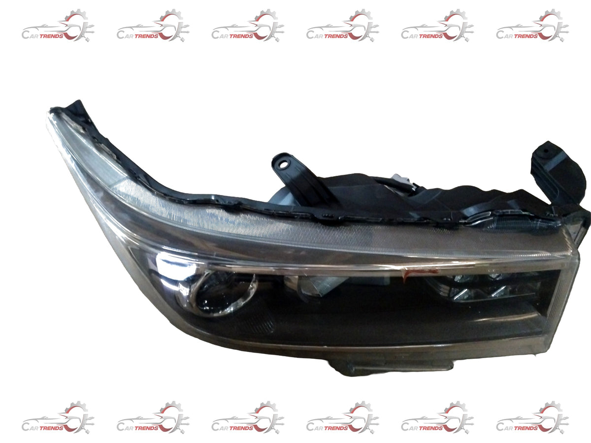 Toyota Hilux or Fortuner headlamp unit assembly, front view showing clear lens, reflective interior, and mounting points.