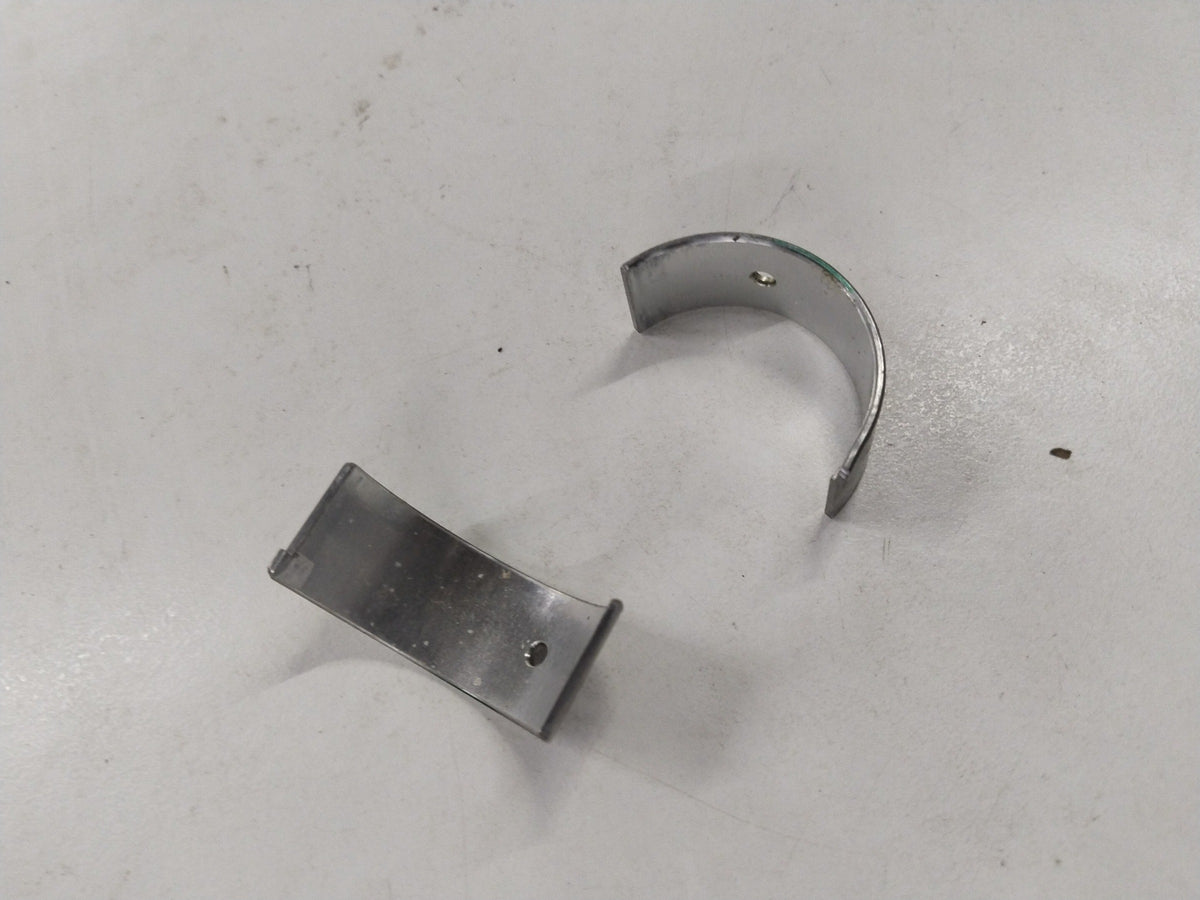 Chevrolet Aveo bearing connecting rod by General Motors, showing metal component with smooth finish and precision-machined surfaces.