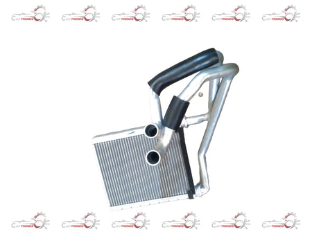Maruti Suzuki heater core sub-assembly for Baleno showing the metal heat exchanger with inlet and outlet pipes.