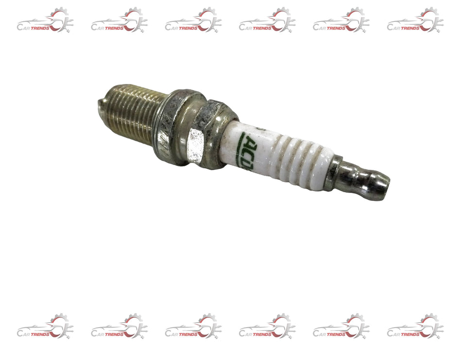 AC Delco spark plug for Chevrolet cars, showing the metal and ceramic components of the ignition part.