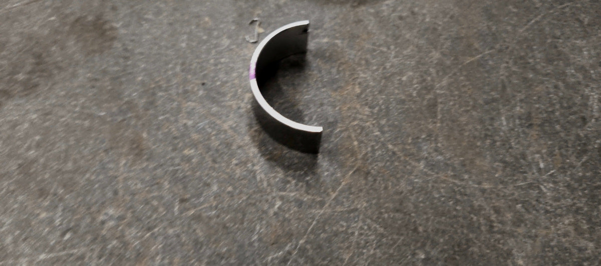 Maruti Suzuki bearing crankshaft for Swift, Baleno, Brezza, and Ertiga vehicles, shown as a lower crankshaft component.