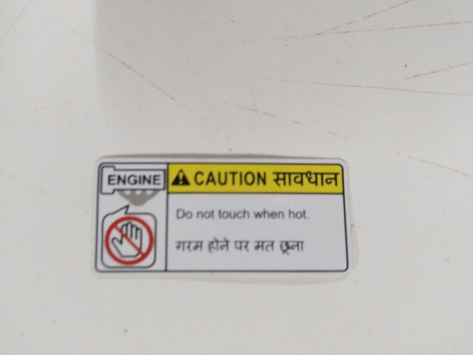 Maruti Suzuki caution label with manufacturing details, featuring black text on a white background.