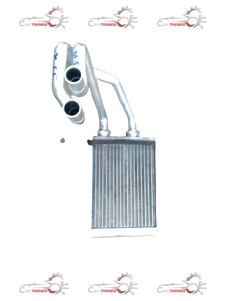 Maruti Suzuki heater core for S-Presso vehicle, showing the metal component with fins and inlet/outlet connections.