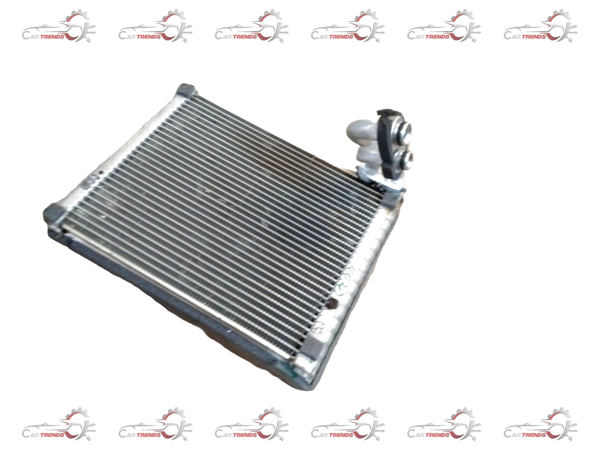 Maruti Suzuki evaporator assembly part 95411M83P00 showing the metal and plastic components of the vehicle's air conditioning system