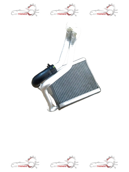 Hyundai Verna heater core showing metal fins and inlet/outlet pipes, replacement auto part for heating system.
