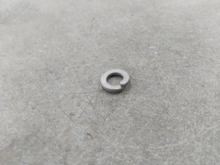 General Motors washer battery retainer for Chevrolet Corsa, showing the plastic clip with mounting details and branding.