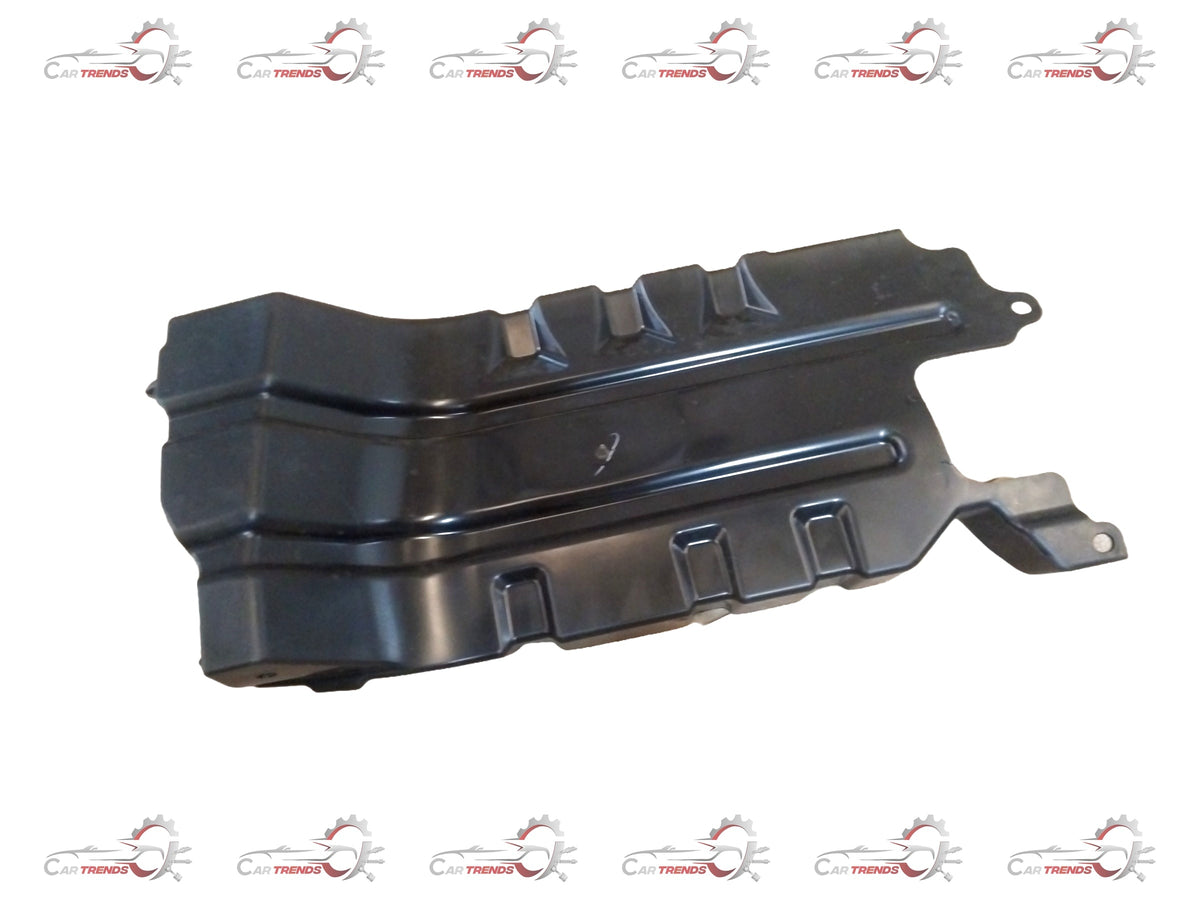 Maruti Suzuki engine front cover showing the protective plastic cover with mounting points and branding details visible.