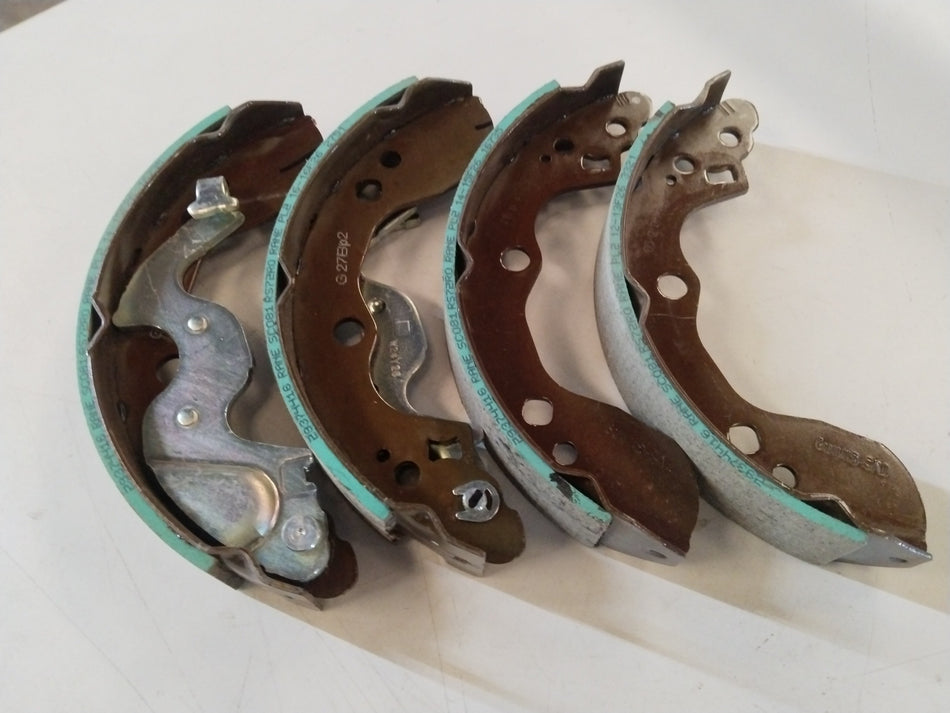 Rear brake shoe for Maruti Suzuki Ertiga, durable automotive part with part number 53200M72R01, shown in the image.