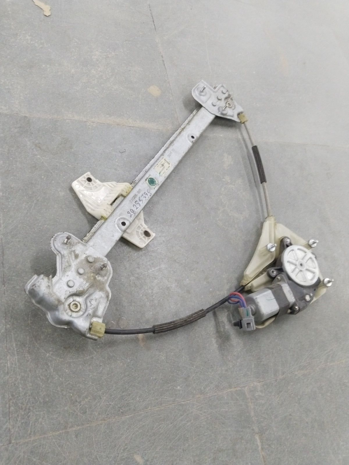 Front left electric window regulator assembly for Chevrolet Spark, by General Motors, showing the motor and linkage components.