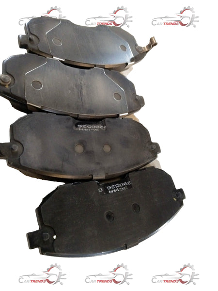 Front brake pad for Maruti Suzuki Brezza and Baleno, showing the metal backing and friction surface of the brake component.