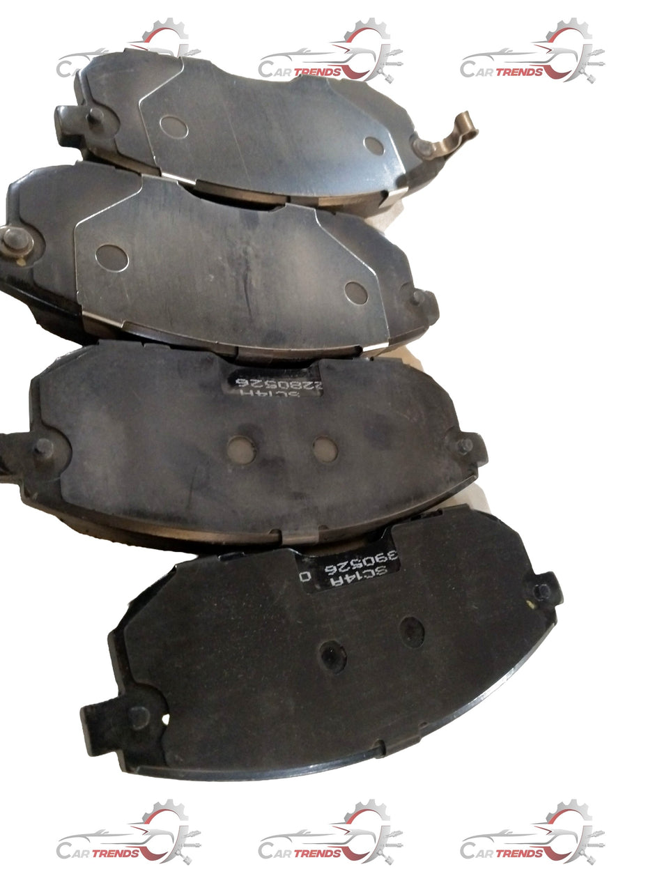 Front brake pad for Maruti Suzuki Brezza and Baleno, showing the metal backing and friction surface of the brake component.