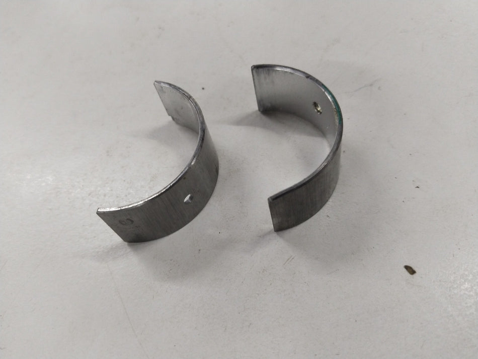General Motors Chevrolet Aveo bearing connecting rod, metallic component with precise machining and engine connection features.