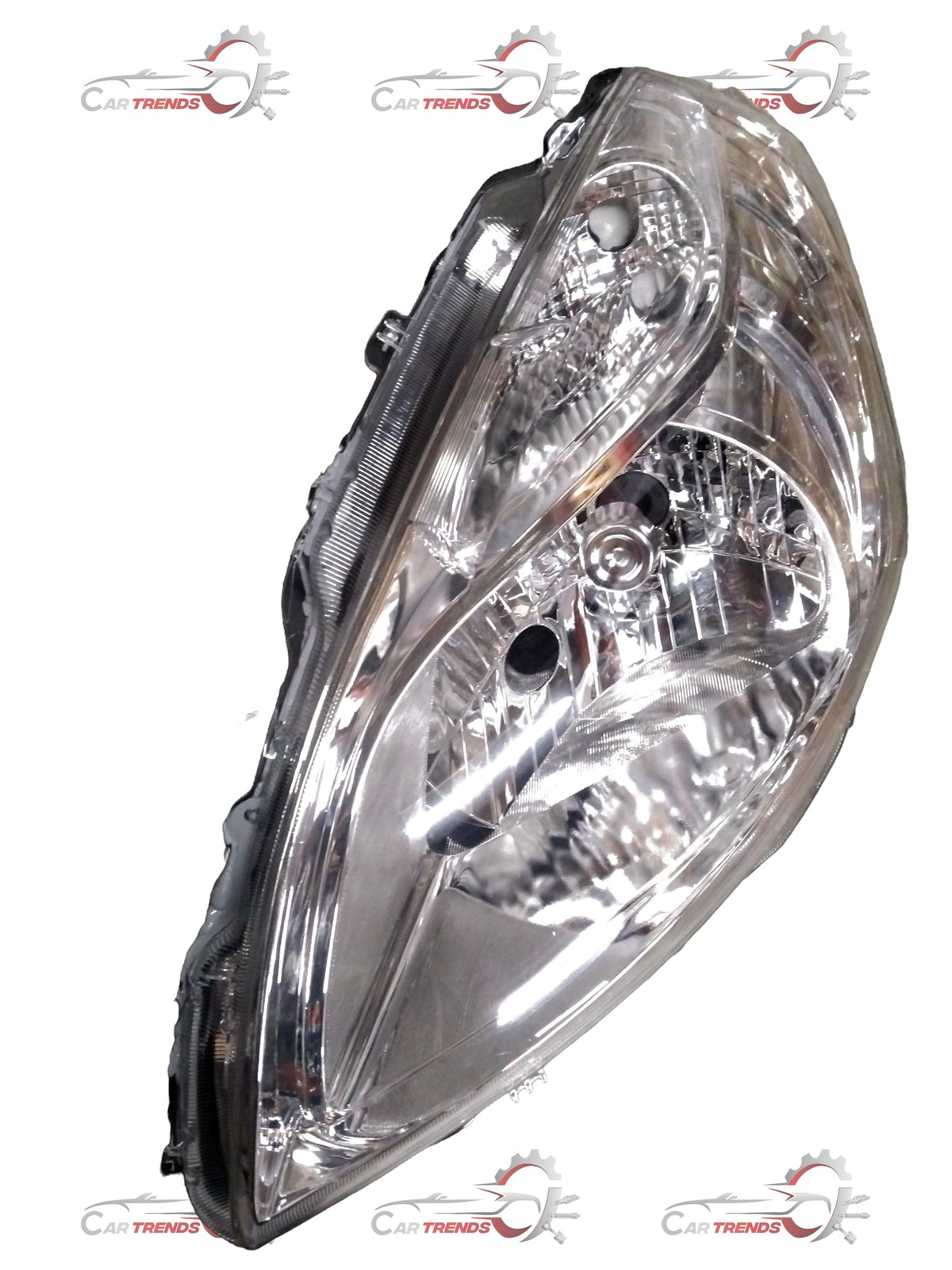 Maruti Ertiga headlight driver side with motor from CarTrends, clear view of the LH headlamp assembly and wiring connection.