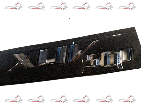 Mahindra badge for XUV500 tailgate, featuring the Mahindra logo and product code #0108FAW00150N, mounted on vehicle tailgate