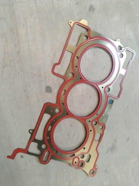 CarTrends Ford cylinder head gasket, showing the gasket's metal and rubber components with detailed edges and surface.
