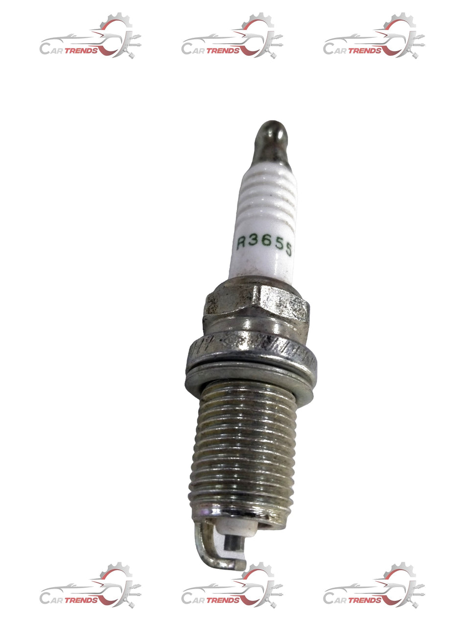 AC Delco spark plug for Chevrolet cars, showing a close-up of the ignition component with metal threads and ceramic insulator.