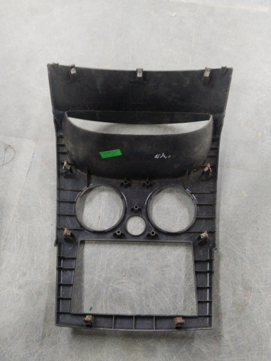General Motors Chevrolet Spark molding assembly cluster with various plastic and metal components, seen from an angled perspective.