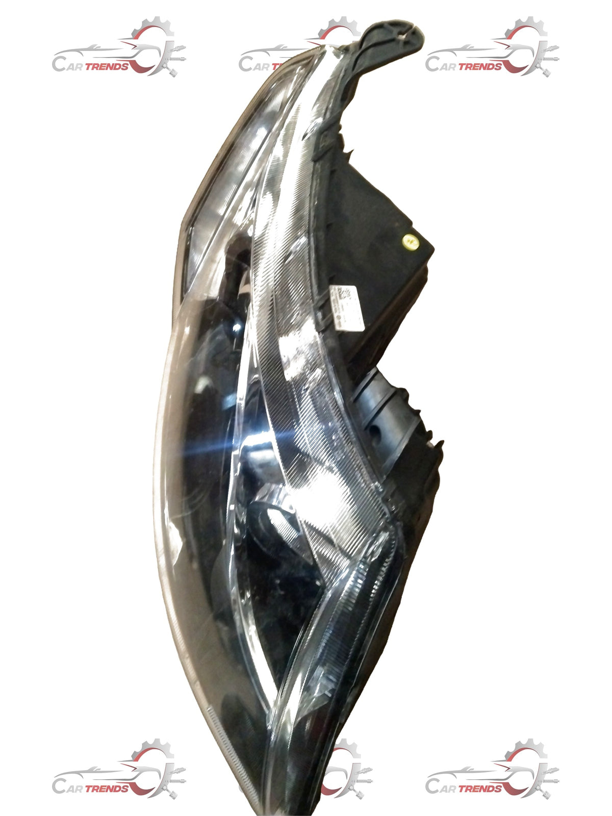 Mahindra XUV 500 right headlamp showing the black housing and clear lens for vehicle front lighting.