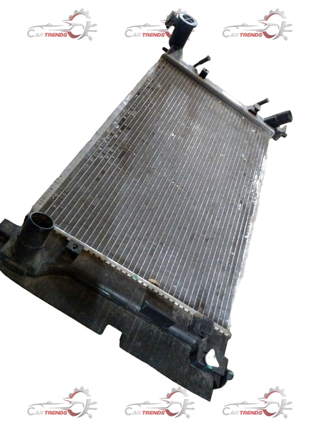 Toyota radiator assembly showing a metal core and tanks, designed for efficient engine cooling in Toyota vehicles.