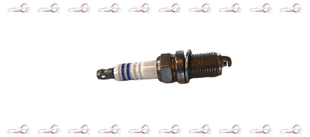 Maruti Suzuki PlugSpark 09482M00655 engine spark plug installed in a vehicle engine.