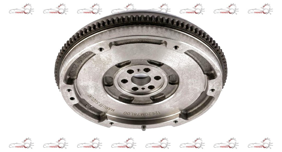 Maruti Suzuki flywheel for Super Carry and Eeco vehicles, close-up of the shiny metal automotive part with gear teeth.