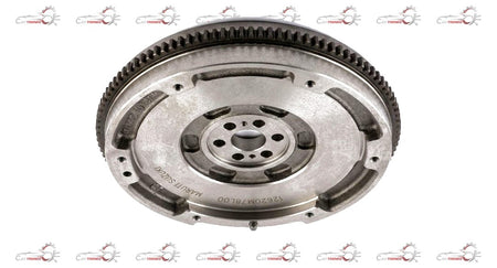 Maruti Suzuki flywheel for Super Carry and Eeco vehicles, close-up of the shiny metal automotive part with gear teeth.