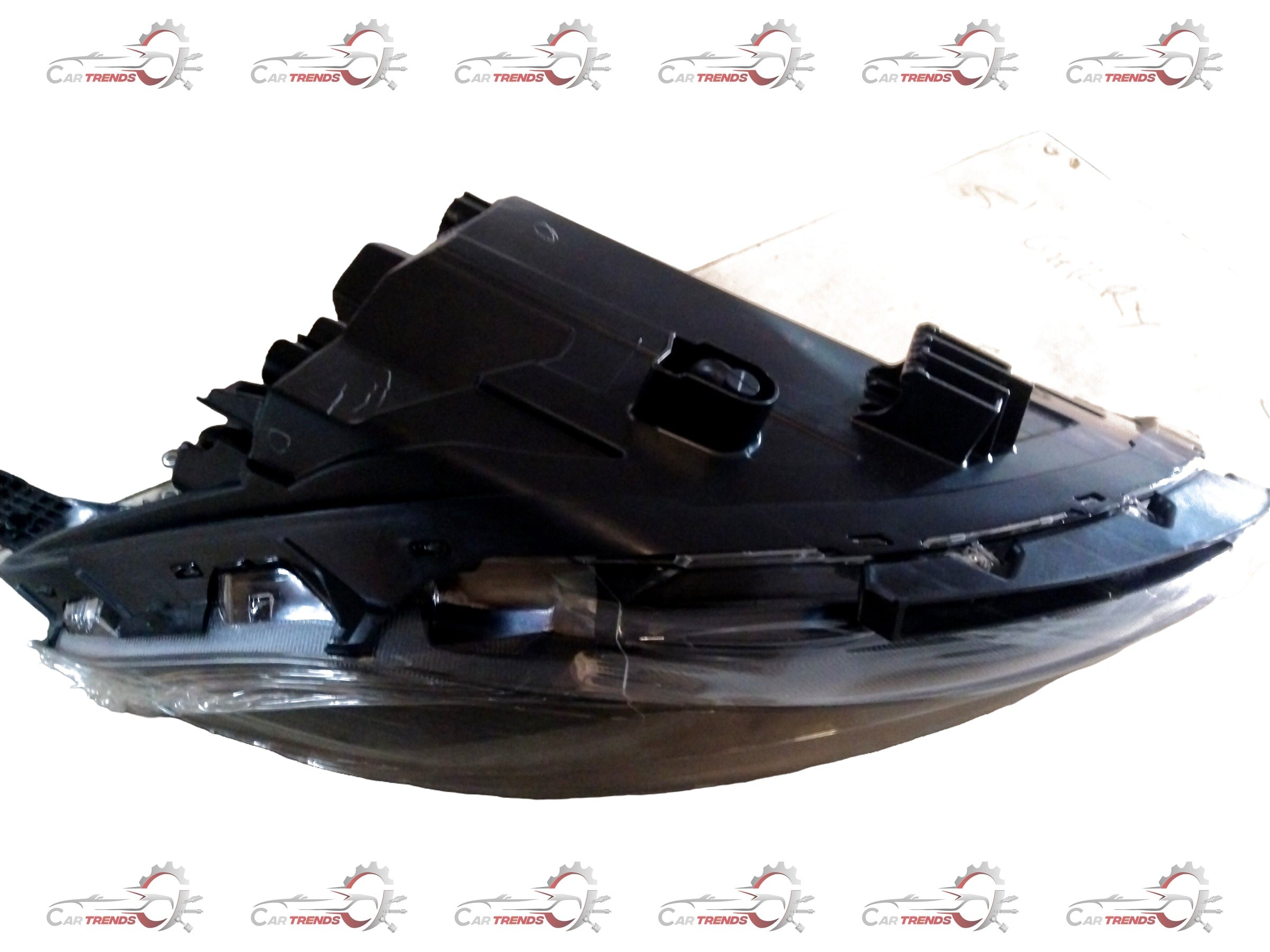 CarTrends I10 Grand Nios headlamp spare part, left-hand side, close-up view showing lens and housing component.