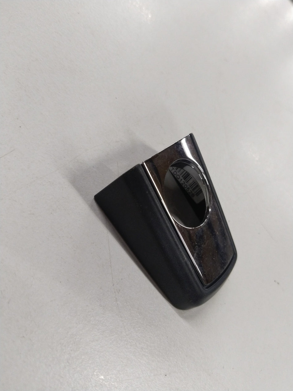 Image of a Chevrolet Cruze side door lock opening cover from General Motors, part number 10552, showing the black plastic component.
