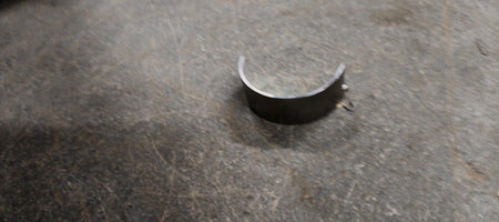 Maruti Suzuki lower crankshaft bearing for Swift, Baleno, Brezza, and Ertiga models, showing the metal bearing component.