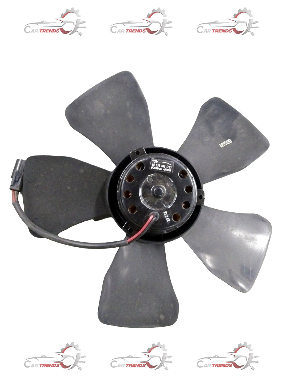 General Motors Chevrolet Aveo blower motor, black plastic component with electrical connectors for vehicle heating and cooling system.