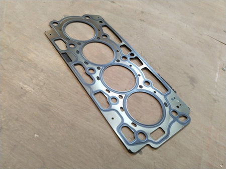 Ford cylinder head gasket by CarTrends, showing a close-up view of the gasket with detailed metal and rubber components.